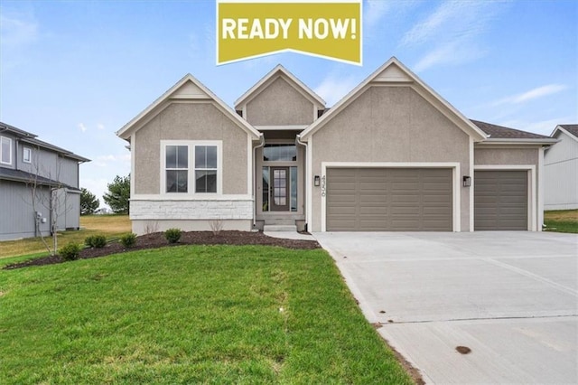 view of front of property featuring a garage and a front lawn