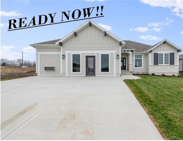 20132 Barker St, Spring Hill, KS 66083 - view of front of property with concrete driveway, board and batten siding, a front yard, and a garage