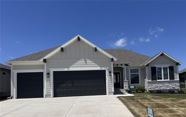 20132 Barker St, Spring Hill, KS 66083 - view of front of property featuring an attached garage, board and batten siding, concrete driveway, and a shingled roof