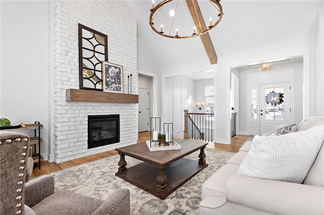 20132 Barker St, Spring Hill, KS 66083 - living room featuring a chandelier, lofted ceiling, wood finished floors, and a fireplace
