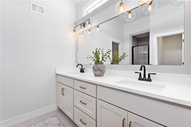 20132 Barker St, Spring Hill, KS 66083 - bathroom featuring tile patterned floors, double vanity, and a shower with door