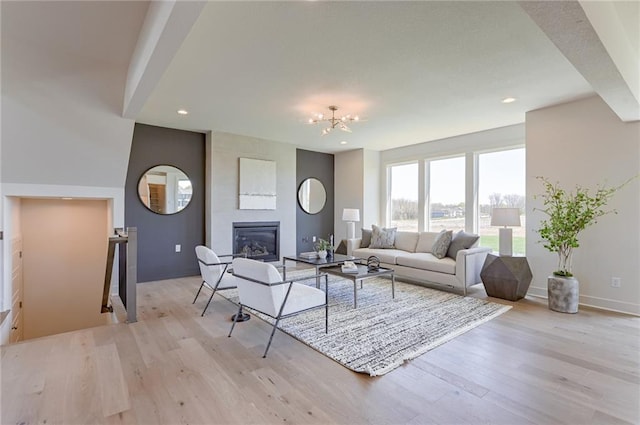 living room featuring a large fireplace and light hardwood / wood-style flooring