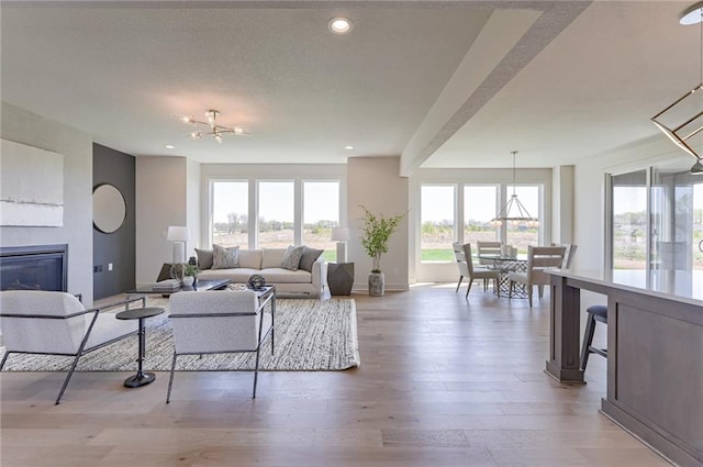 living room with hardwood / wood-style flooring and a notable chandelier