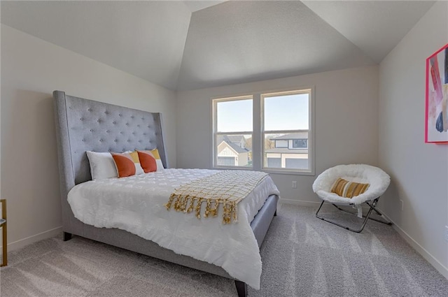 carpeted bedroom featuring lofted ceiling