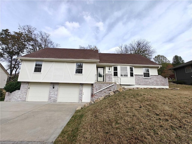 view of front of house with a front yard and a garage