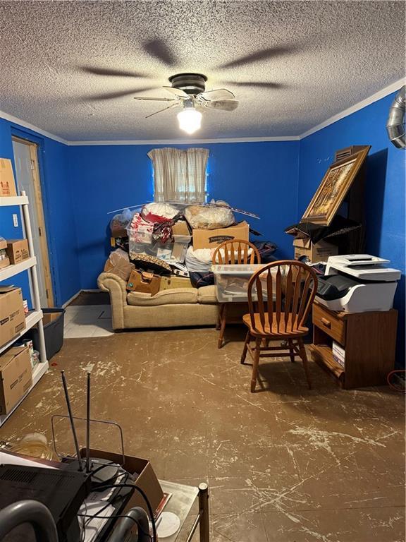 sitting room with a textured ceiling, ceiling fan, and crown molding