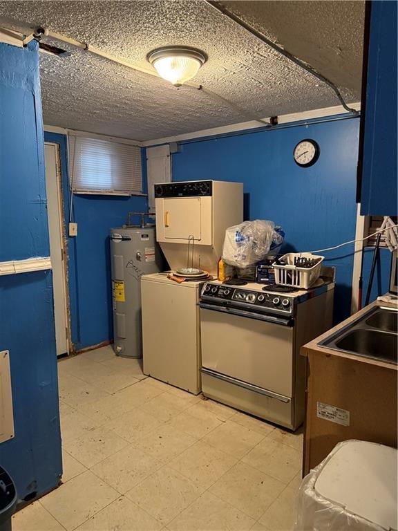 kitchen with separate washer and dryer, water heater, and range