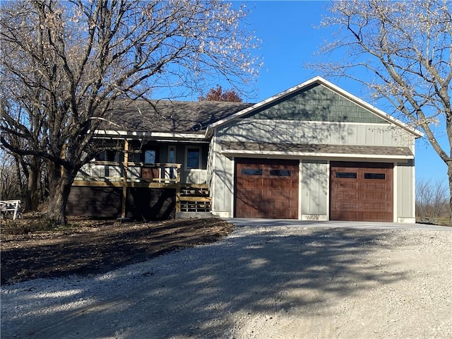 single story home featuring a wooden deck and a garage