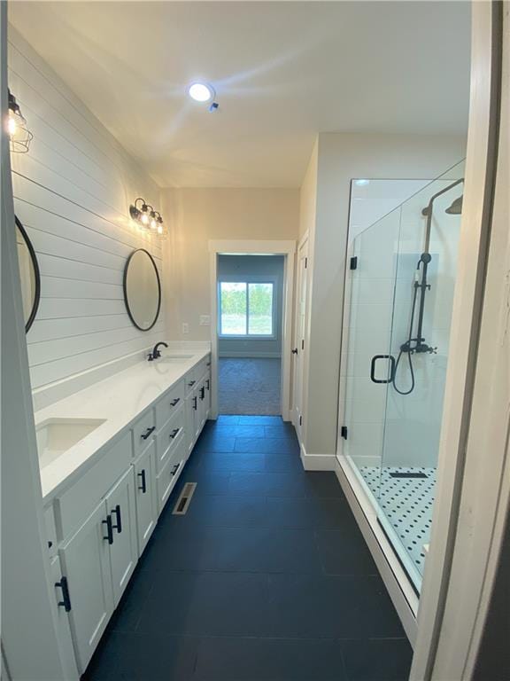 bathroom with vanity, tile patterned flooring, and a shower with door