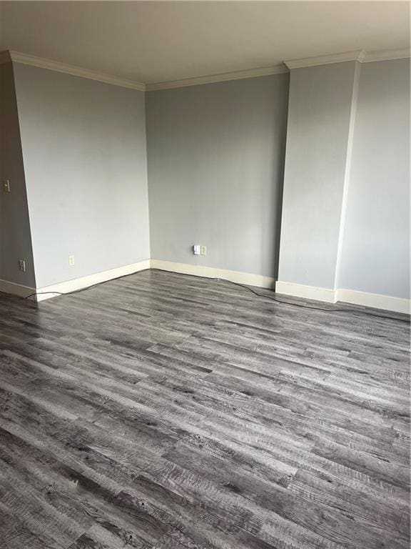 unfurnished room featuring dark hardwood / wood-style flooring and crown molding