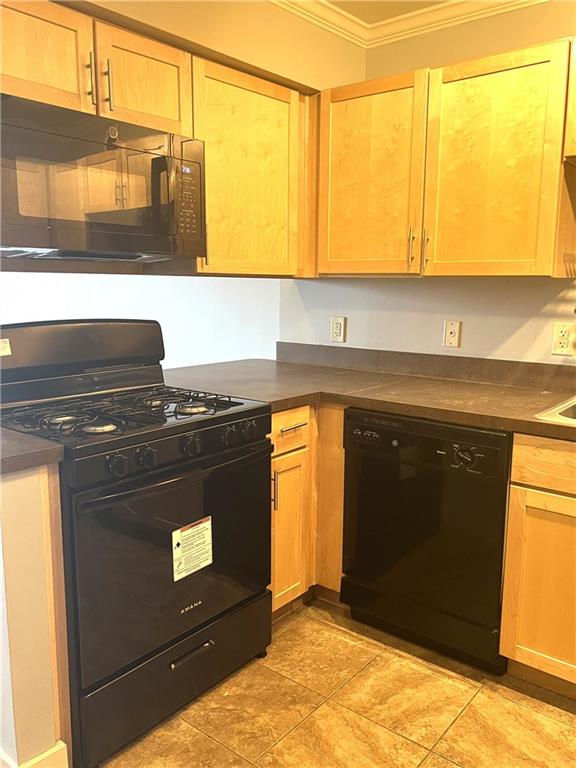 kitchen with crown molding, black appliances, and light tile floors