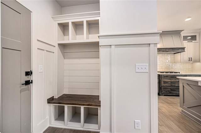 mudroom with wood finished floors and recessed lighting