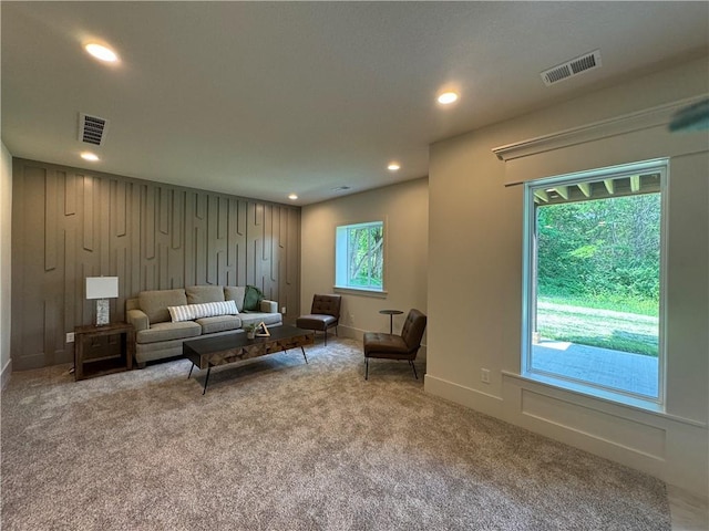 carpeted living area featuring recessed lighting, visible vents, and baseboards