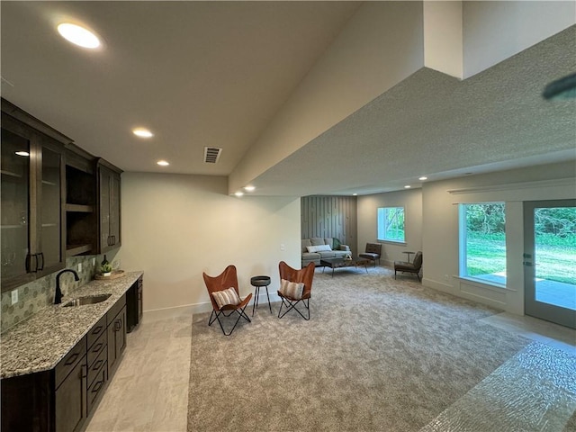 interior space featuring light carpet, baseboards, visible vents, and recessed lighting