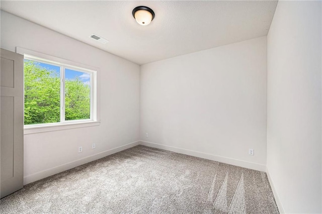 carpeted empty room with baseboards and visible vents