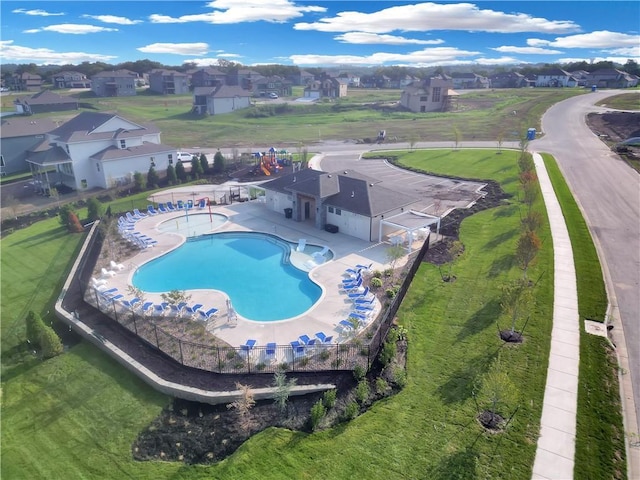 pool featuring a patio area, a fenced backyard, and a residential view