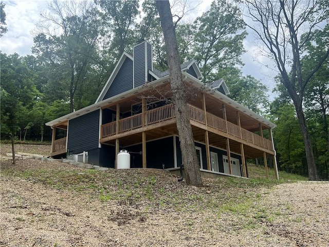 7930 Eagle Bay Dr, Gravois Mills, MO 65037 - back of property featuring a chimney and a wooden deck