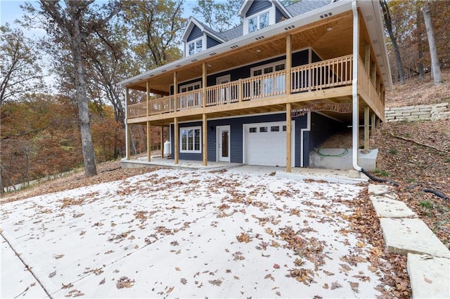 rear view of house featuring a garage