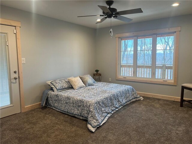 carpeted bedroom featuring multiple windows and ceiling fan