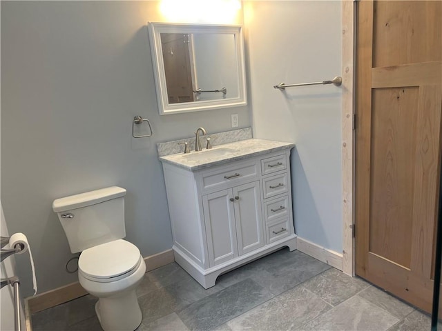 bathroom featuring vanity, toilet, and tile floors