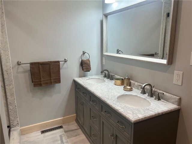 bathroom with double vanity and tile flooring