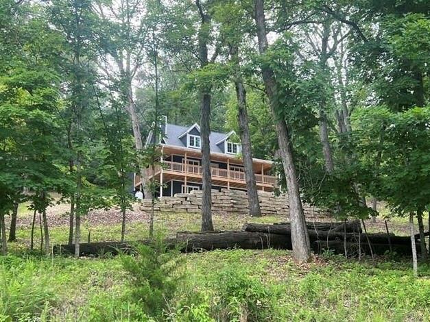 7930 Eagle Bay Dr, Gravois Mills, MO 65037 - rear view of property with a forest view and a wooden deck