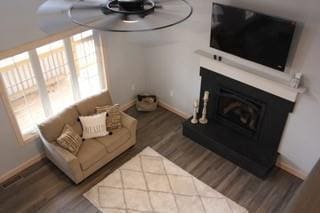 7930 Eagle Bay Dr, Gravois Mills, MO 65037 - living area featuring wood finished floors, baseboards, and a fireplace with raised hearth