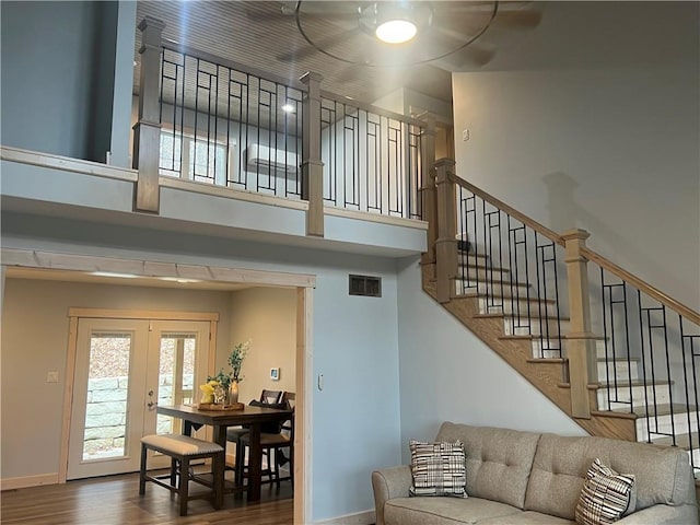 7930 Eagle Bay Dr, Gravois Mills, MO 65037 - living area featuring visible vents, ceiling fan, a towering ceiling, wood finished floors, and stairs