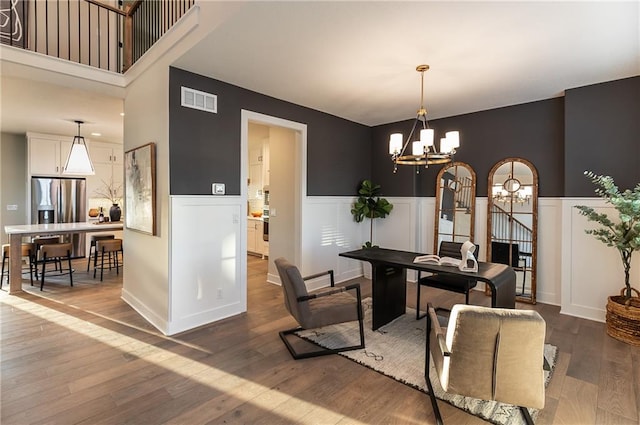 dining space with a notable chandelier and hardwood / wood-style flooring