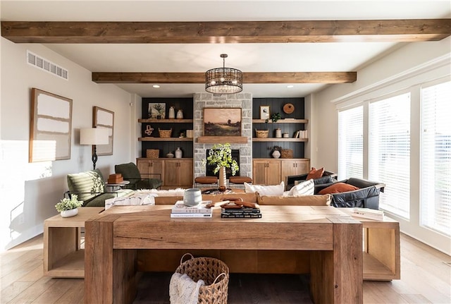 interior space featuring visible vents, plenty of natural light, and light wood-style flooring