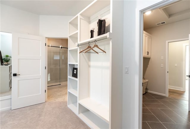 mudroom with visible vents, dark tile patterned floors, and baseboards