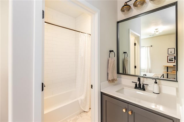 full bath with shower / tub combo, vanity, and marble finish floor