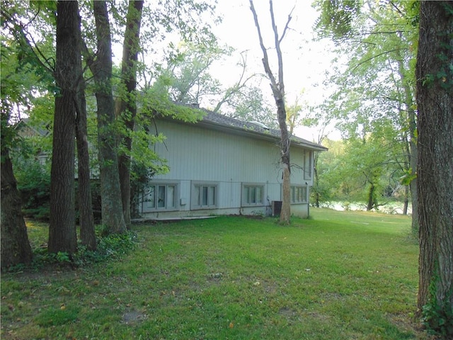 rear view of house featuring a yard