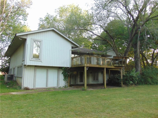 rear view of house featuring a lawn and a wooden deck