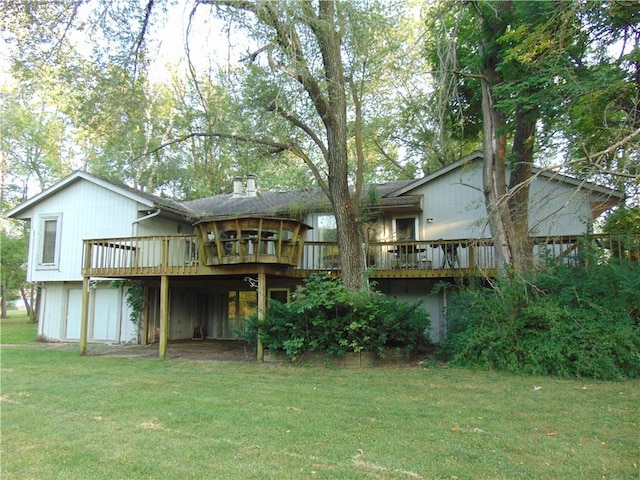 rear view of property with a deck and a yard