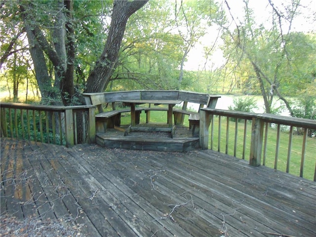 wooden deck featuring a lawn