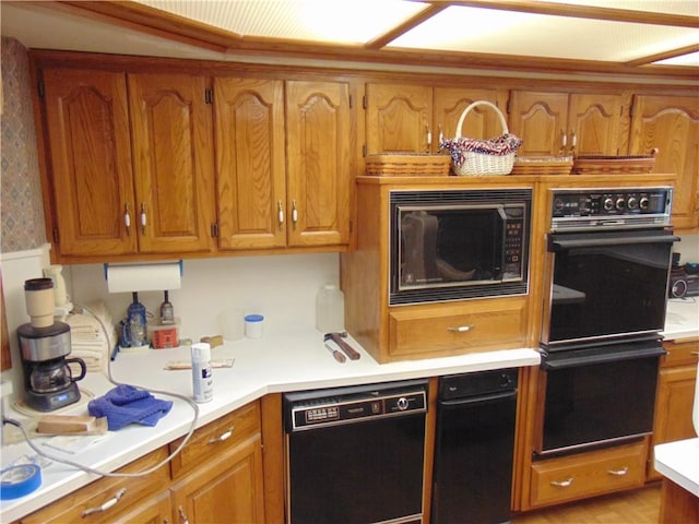 kitchen with light wood-type flooring and black appliances