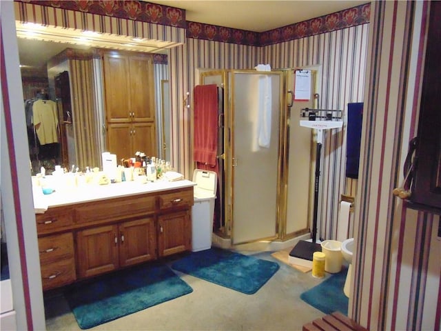 bathroom with vanity, a shower with door, a bidet, and toilet