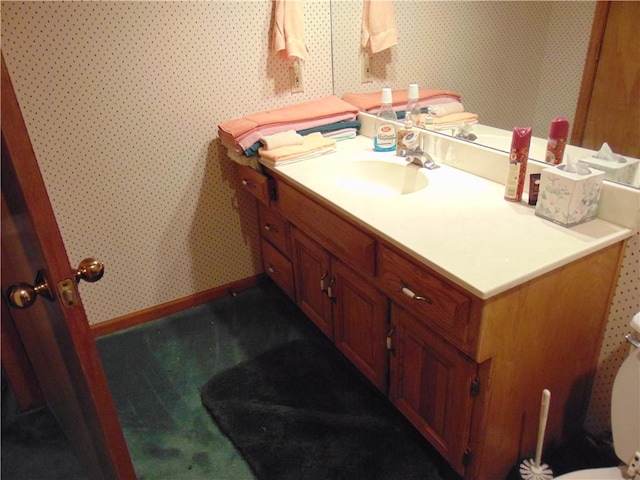 bathroom featuring toilet and vanity