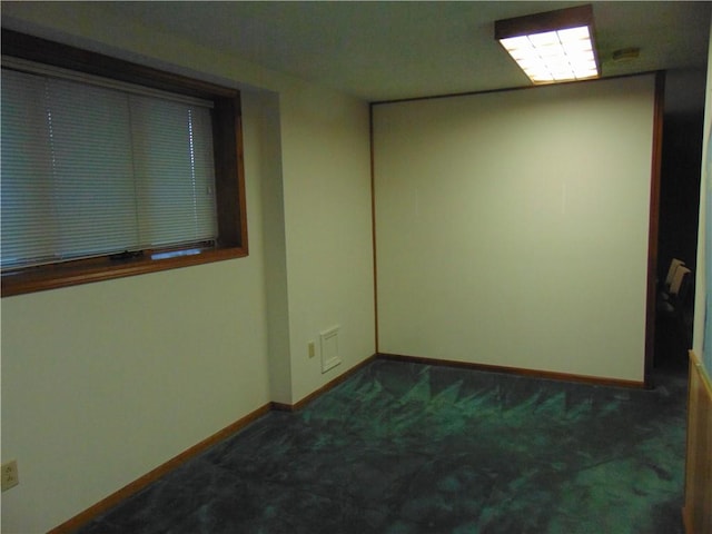 empty room featuring dark carpet