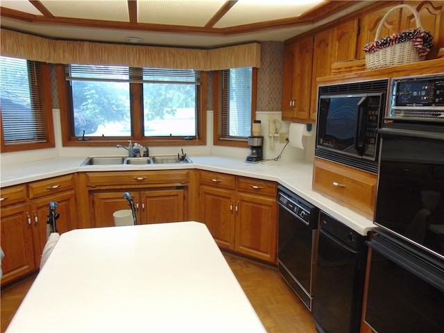 kitchen featuring light parquet floors, sink, black appliances, and ceiling fan