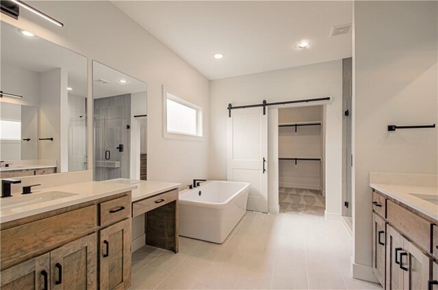 7551 NW Gower Ave, Kansas City, MO 64151 - bathroom featuring a sink, a stall shower, two vanities, a freestanding bath, and baseboards