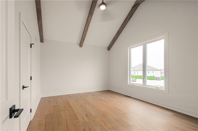 7551 NW Gower Ave, Kansas City, MO 64151 - interior space featuring baseboards, visible vents, vaulted ceiling with beams, and light wood-style floors