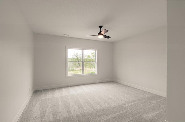 7551 NW Gower Ave, Kansas City, MO 64151 - spare room with visible vents, ceiling fan, light carpet, and baseboards