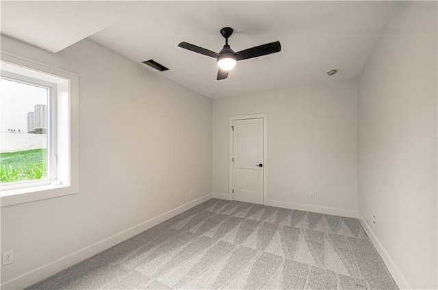 7551 NW Gower Ave, Kansas City, MO 64151 - empty room with visible vents, ceiling fan, light carpet, and baseboards