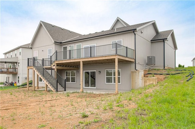 7551 NW Gower Ave, Kansas City, MO 64151 - back of property featuring stairway, a deck, central AC, and a shingled roof