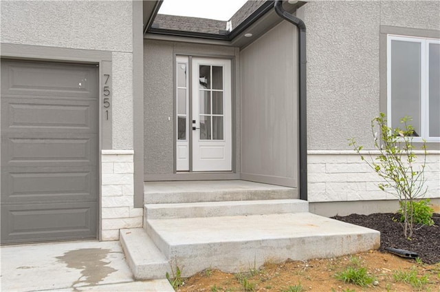7551 NW Gower Ave, Kansas City, MO 64151 - property entrance with a garage and stucco siding