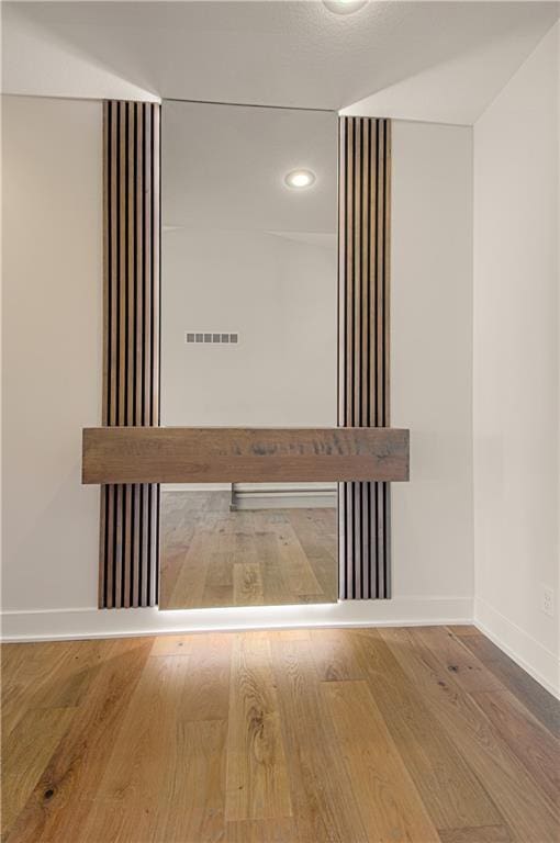 7551 NW Gower Ave, Kansas City, MO 64151 - details featuring baseboards, visible vents, wood finished floors, and recessed lighting