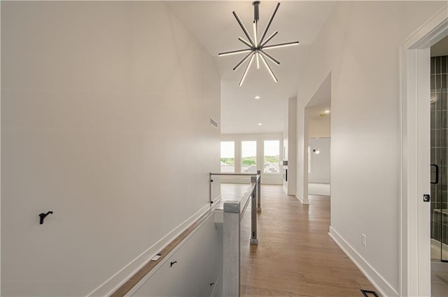 7551 NW Gower Ave, Kansas City, MO 64151 - hall featuring visible vents, an inviting chandelier, an upstairs landing, baseboards, and light wood-type flooring
