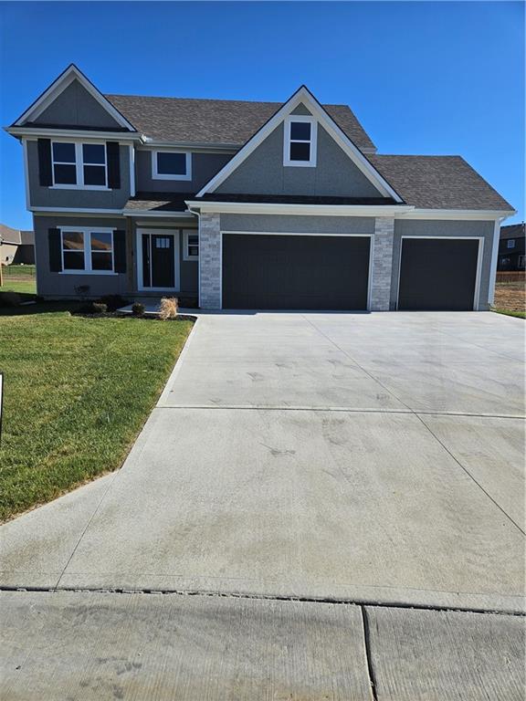 view of front of house with a garage and a front yard